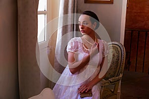 Regency reenactment by young woman in lace dress