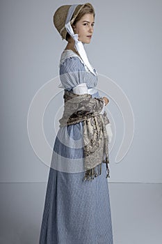 Regency woman in blue striped dress on plain background