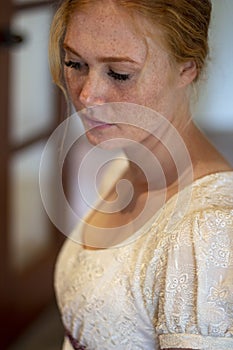 Regency woman in cream dress in a beautiful room