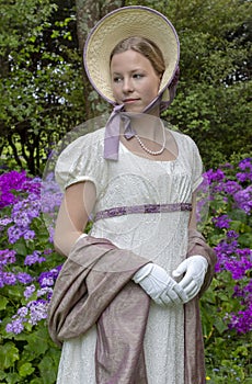 Regency woman in a cream dress, paisley shawl and bonnet