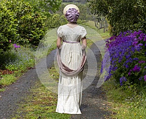 Regency woman in a cream dress, paisley shawl and bonnet