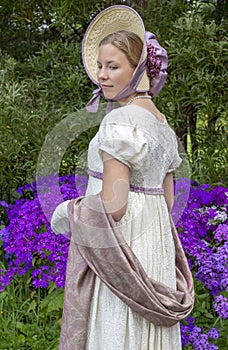 Regency woman in a cream dress, paisley shawl and bonnet