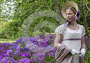 Regency woman in a cream dress, paisley shawl and bonnet photo