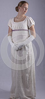 Regency woman in cream dress on studio backdrop