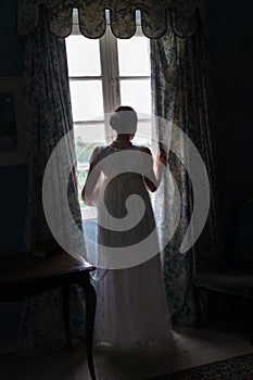 Regency woman in dark room photo