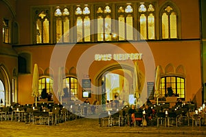 People have late dinner in a street cafe in Regensburg, Germany.