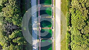 Reggia di Caserta, Italy. Aerial view of famous royal building gardens and pools from a drone in summer season