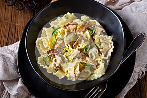 Reginette noodles in cream sauce with fresh chanterelles and capers