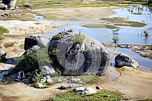 Big rocks and undergrowth with some vegetation in the region close to the sea, northeast of Brazil. photo
