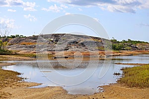 Big rocks, river  and undergrowth with some vegetation in the region close to the sea, northeast of Brazil. photo