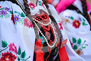 Regional, folklore costumes, colorful handmade shirts and necklaces.