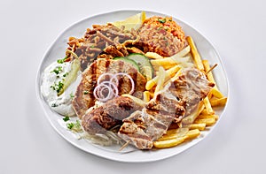 Regional Greek mixed grill with chips and pilaf