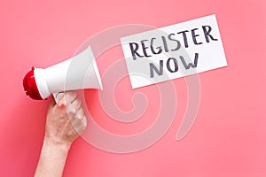 Register now hand lettering icon near megaphone on pink background top view copy space