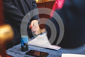 Registration desk table, process of checking in on a conference congress forum event, visitors and attendees receiving a name