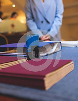 Registration desk table, process of checking in on a conference congress forum event, visitors and attendees receiving a name