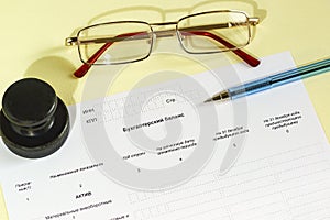 Registration of the report document, printing, glasses and pen on the table