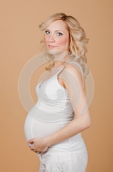 Regnant woman in a white dress