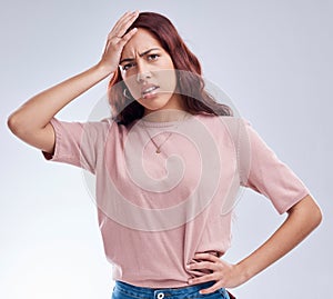 Regret, mistake and young woman in studio with hand on head for anxiety, stress or panic. Portrait of a frustrated