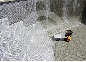 Regrouting in progress on a leaky swimming pool.