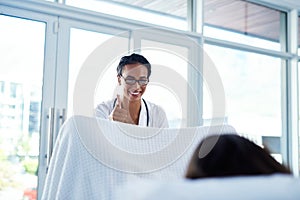 Regular cervical screening can save your life. a young gynaecologist giving a thumbs up during a consultation with her photo