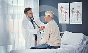 Regular checkups are vital for seniors. a doctor examining a senior patient with a stethoscope in a clinic.