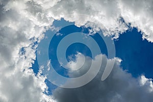 Regular spring clouds on blue sky at daylight in continental europe. Close shot wit telehoto lens and polarizing filter.