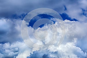 Regular spring clouds on blue sky at daylight in continental europe. Close shot wit telehoto lens and polarizing filter.