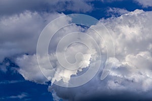 Regular spring clouds on blue sky at daylight in continental europe. Close shot wit telehoto lens and polarizing filter.