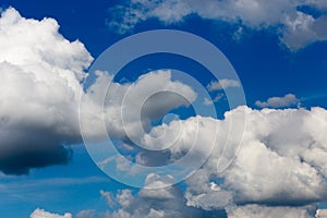 Regular spring clouds on blue sky at daylight in continental europe. Close shot wit telehoto lens and polarizing filter.