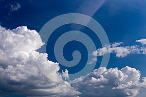 Regular spring clouds on blue sky at daylight in continental europe. Close shot wit telehoto lens and polarizing filter.