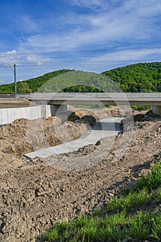 Work on the development of a stream bed against erosion and flooding.