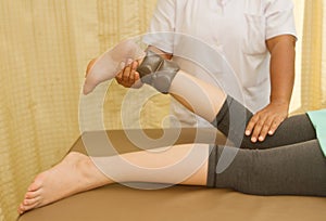 Rehab training for knee and hamstring muscle with physical therapist photo