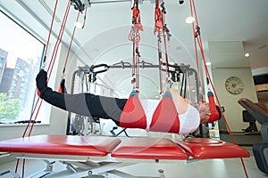 Rehabilitation center patient undergoing sling exercise therapy