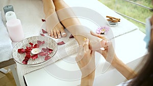 Rehabilitation and foot and foot massage in a modern spa with panoramic windows. Health and self-care