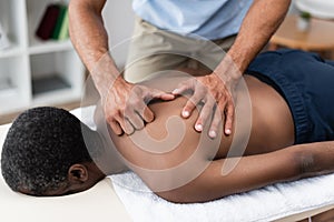 rehabilitologist treating african american man while