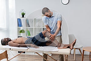 rehabilitologist treating middle aged african american