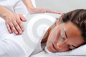 Reiki therapist doing treatment on woman. photo