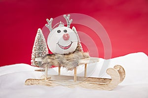 A reindeer bauble sitting on a sleigh, copy space