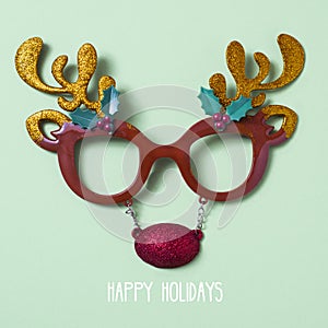 Reindeer eyeglasses and text happy holidays