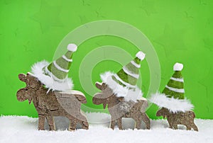 Reindeer family on green and white wooden christmas background w