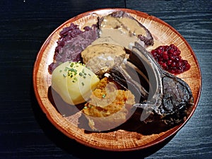 Reindeer meat in different forms with homemade vegetable dishes for christmas