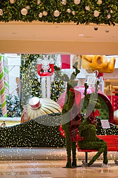 Reindeer sitting on a bench at Aventura Mall for holiday season decoration