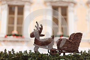 Reindeer with sleigh on the roof of a christmas market stand