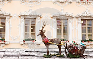 Reindeer with sleigh on the roof of a christmas market stand