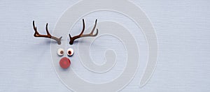 Reindeer toy with red nose Christmas background concept