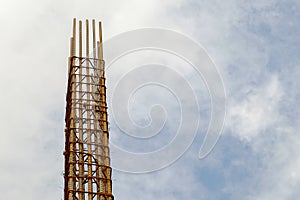 Reinforce concrete column construction with sky background