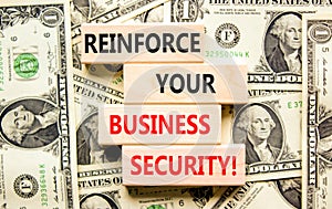 Reinforce your business security symbol. Concept word Reinforce your business security on blocks. Beautiful background from dollar