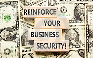 Reinforce your business security symbol. Concept word Reinforce your business security on blocks. Beautiful background from dollar