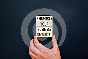 Reinforce your business security symbol. Concept word Reinforce your business security on blocks. Beautiful black table black