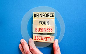 Reinforce your business security symbol. Concept word Reinforce your business security on blocks. Beautiful blue table blue